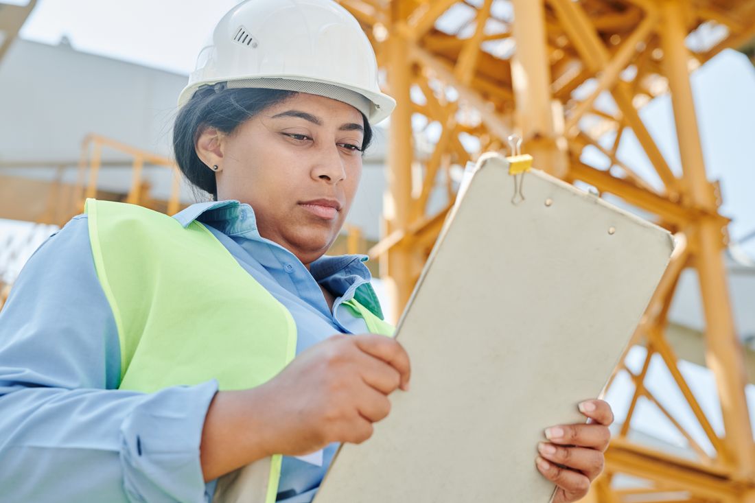RICS surveyor comparing survey levels on a property